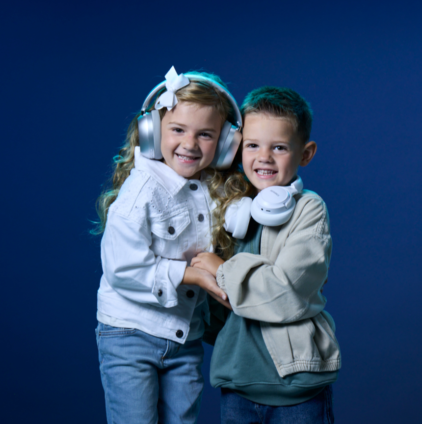 Kids with headphones on a blue backdrop